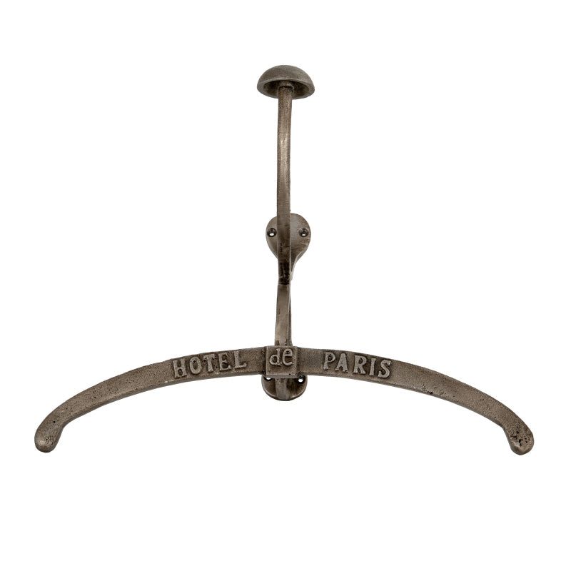 Metal coat rack with 'Hotel de Paris' inscription on a white background