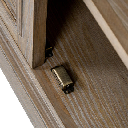 Close-up of a wooden cabinet with a brass handle