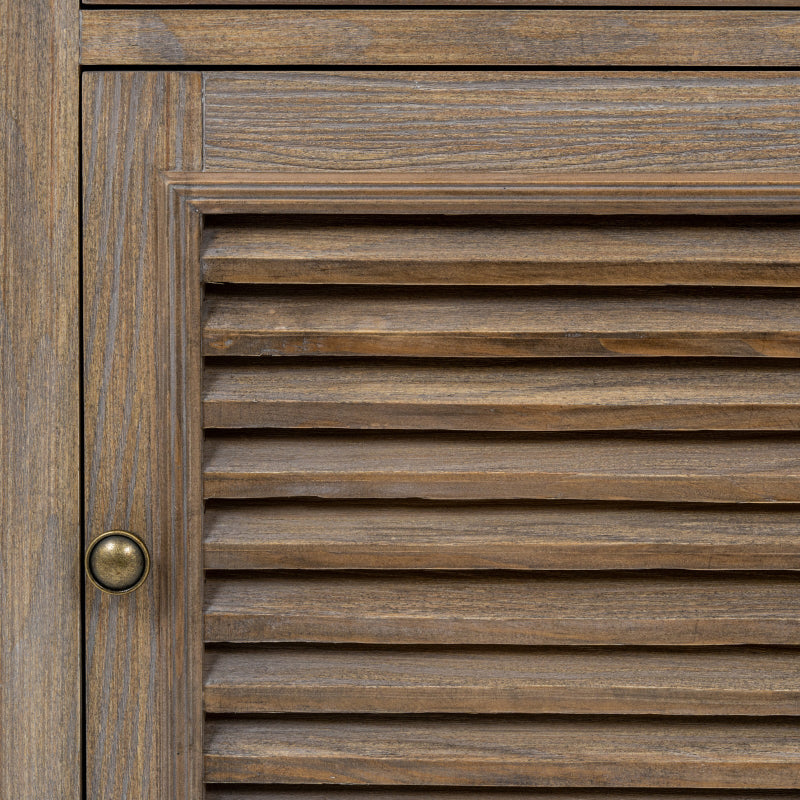 Close-up of a wooden door with horizontal slats and a brass handle.