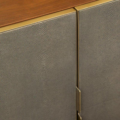 Close-up of a wooden and leather cabinet with gold accents