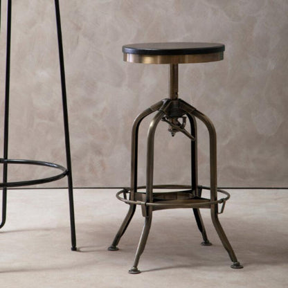 Vintage-style adjustable bar stool against a neutral wall.