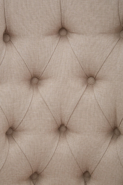 Close-up of a textured beige fabric with buttonhole pattern
