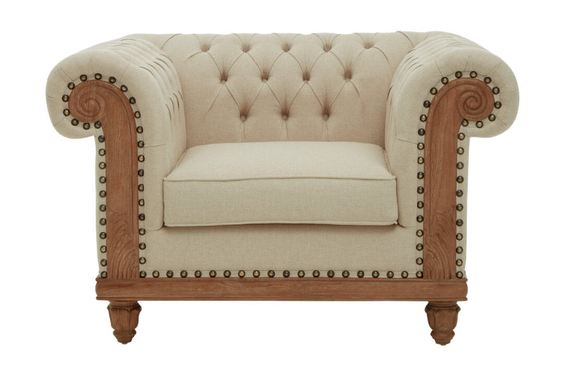 Beige armchair with wooden frame and nailhead trim on a white background