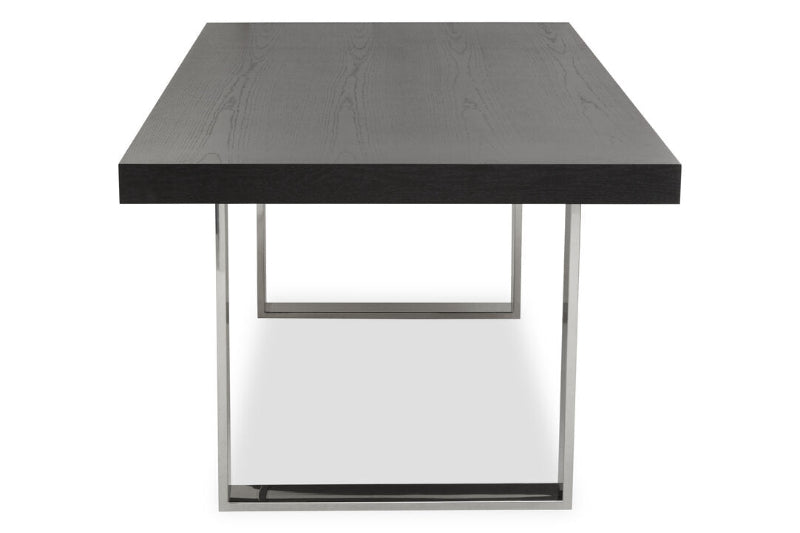 Modern dining table with black top and silver frame on a white background
