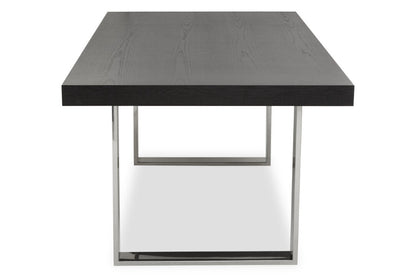 Modern dining table with black top and silver frame on a white background