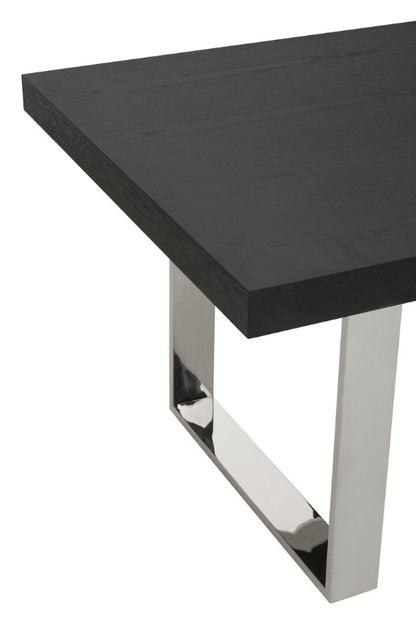 Black table with chrome legs on a white background