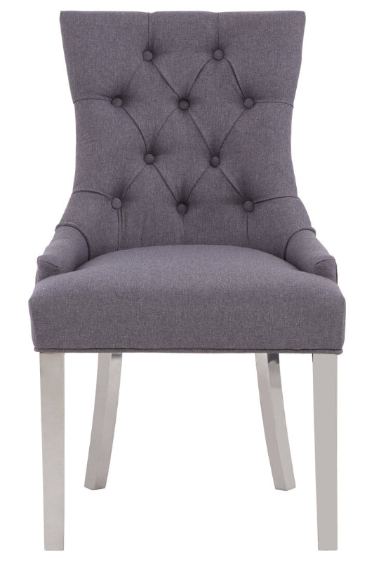 Gray upholstered chair with tufted backrest on a white background