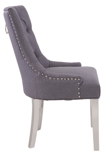 Gray upholstered chair with silver nailhead trim on a white background