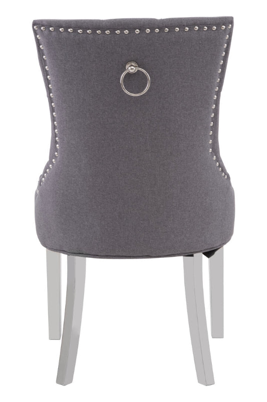 Gray upholstered chair with silver ring and legs on a white background