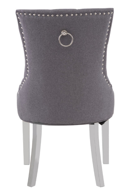 Gray upholstered chair with silver ring and legs on a white background
