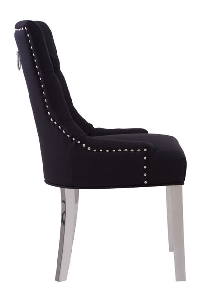 Black upholstered chair with silver nailhead trim on a white background