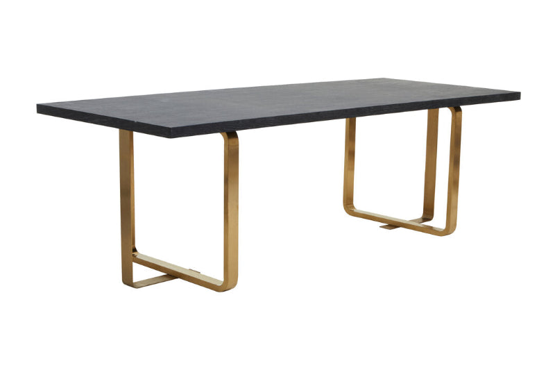 Dining table with black top and gold metal legs on a white background