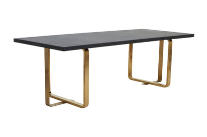 Dining table with black top and gold metal legs on a white background