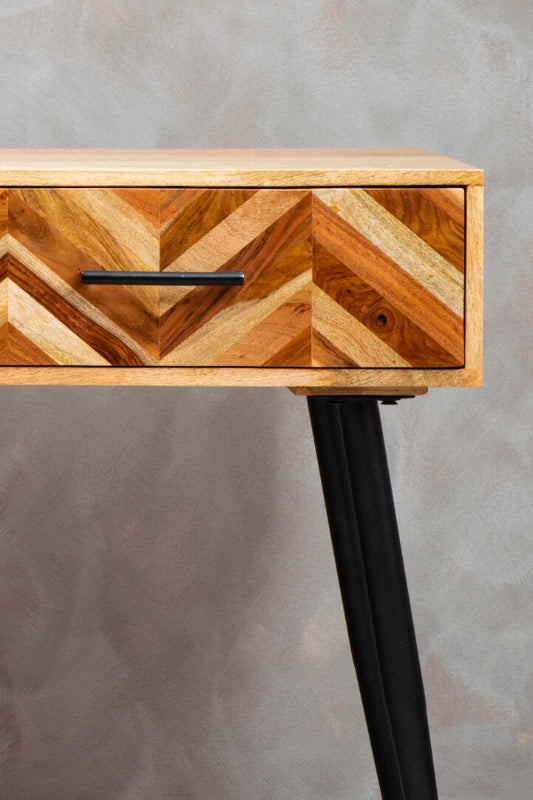 Wooden drawer with chevron pattern on a gray background