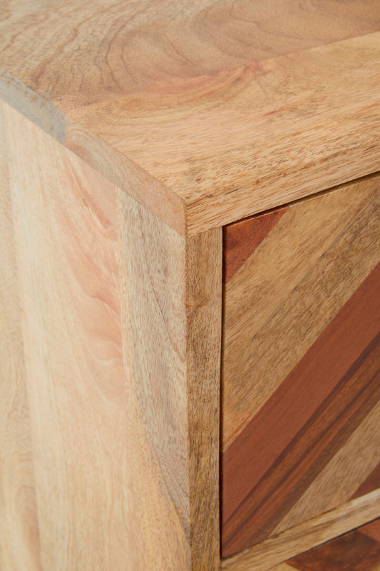 Close-up of a wooden cabinet with a focus on the corner and texture.