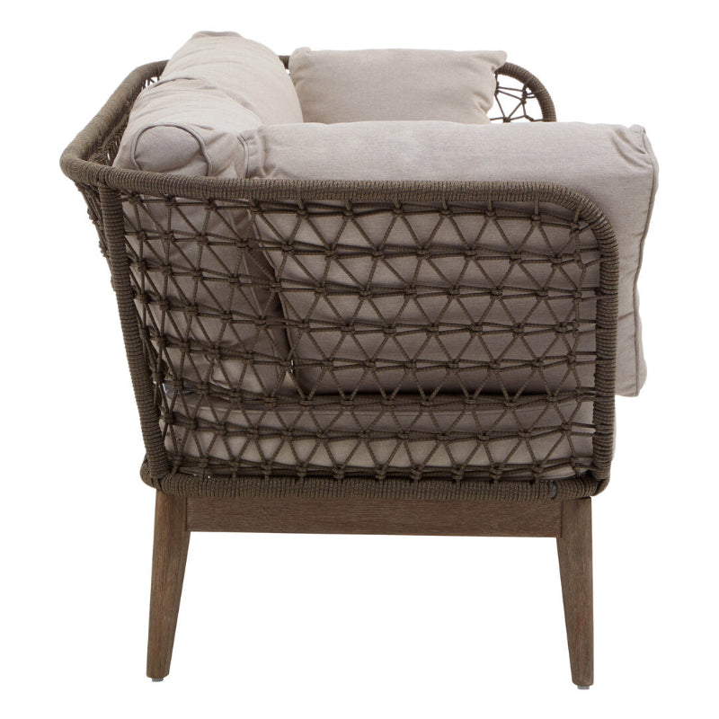 Wicker chair with beige cushions on a white background