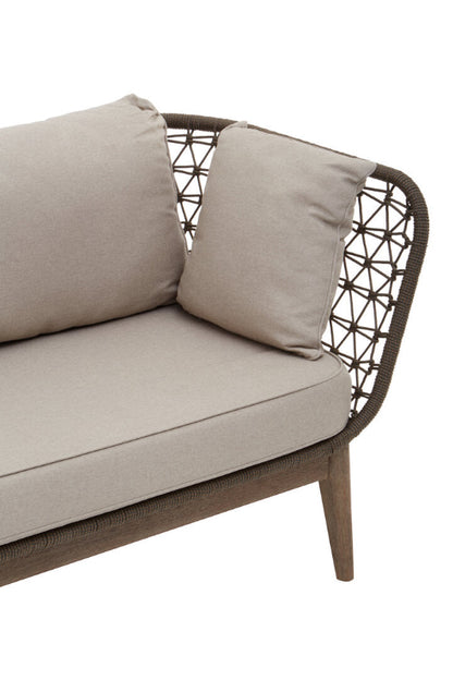 Beige outdoor sofa with woven backrest on a white background