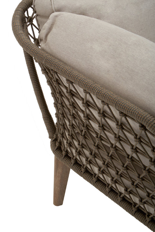 Wicker chair with beige cushion on a white background