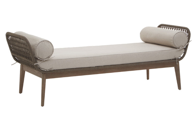 Wicker daybed with beige cushions on a white background