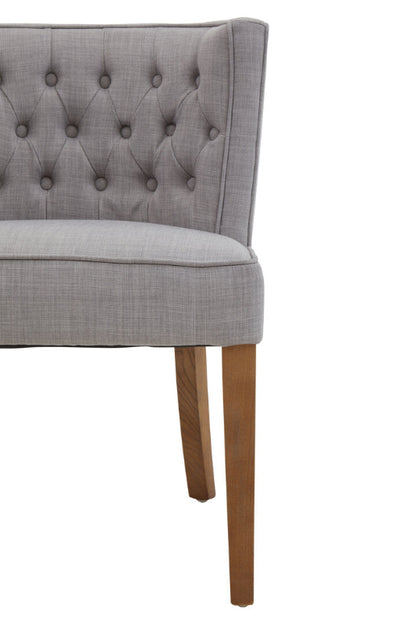 Gray upholstered chair with wooden legs on a white background