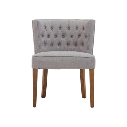 Grey upholstered chair with wooden legs on a white background