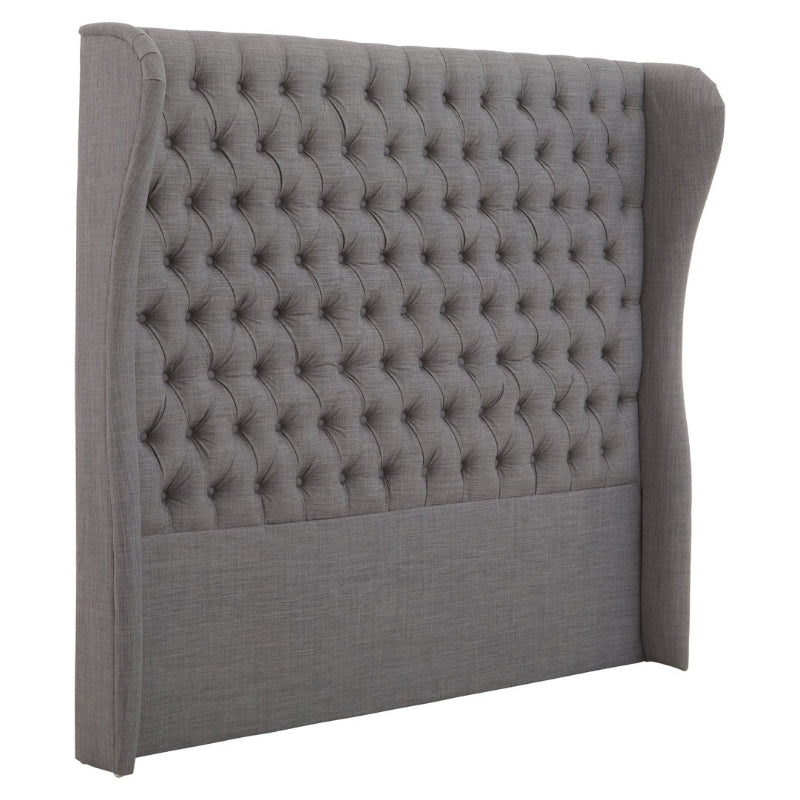 Gray tufted headboard on a white background
