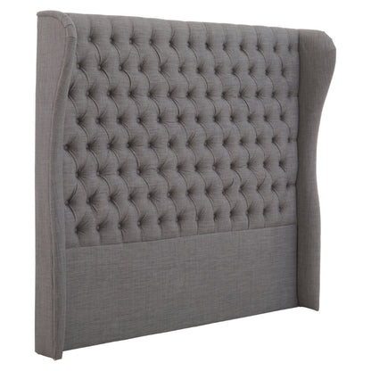 Gray tufted headboard on a white background