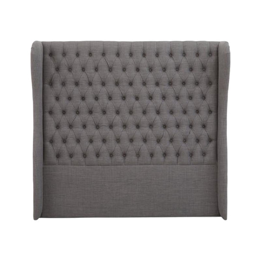 Gray tufted headboard on a white background