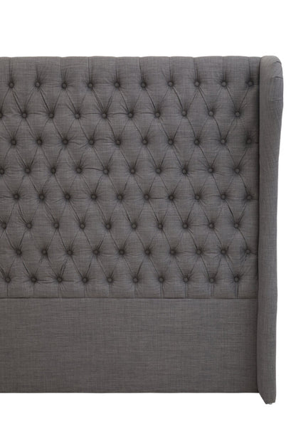 Gray tufted headboard on a white background