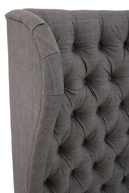 Gray tufted headboard with a textured finish