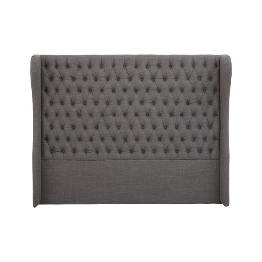 Gray tufted headboard on a white background