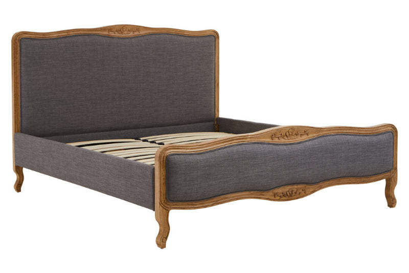 Grey upholstered bed with wooden frame on a white background