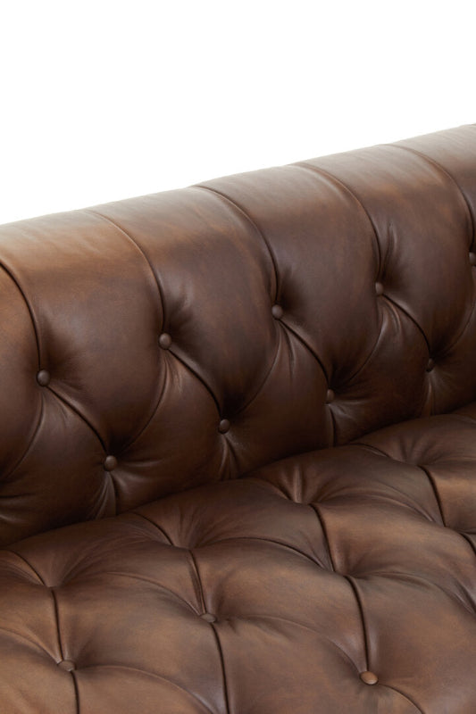 Brown leather sofa with tufted backrest on a white background