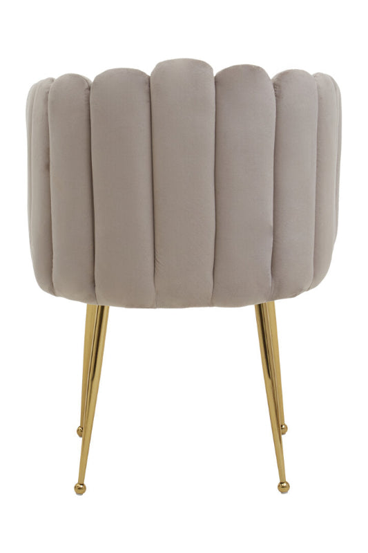 Beige velvet chair with gold legs on a white background