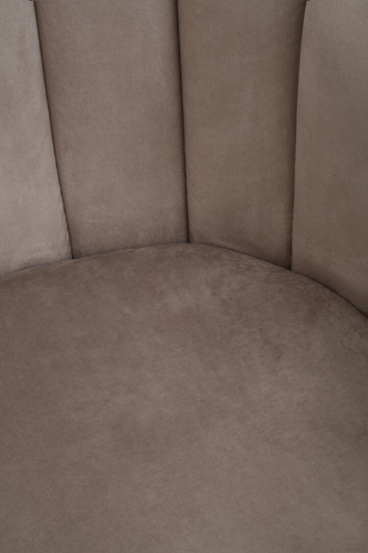 Close-up of a brown upholstered chair corner