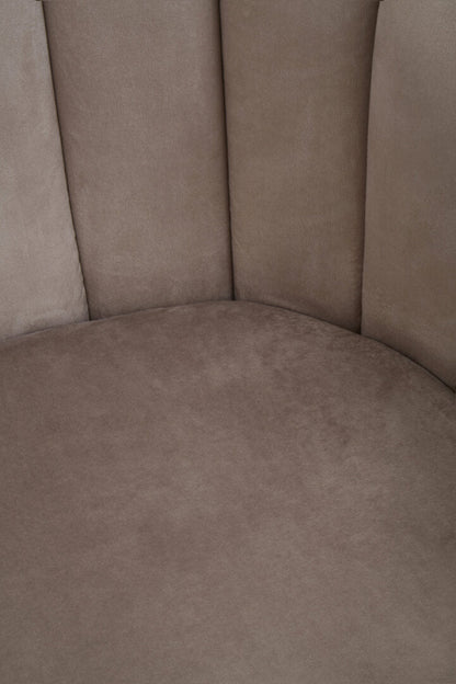 Close-up of a brown upholstered chair corner