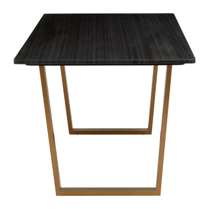 Dining table with black marble top and gold metal legs on a white background