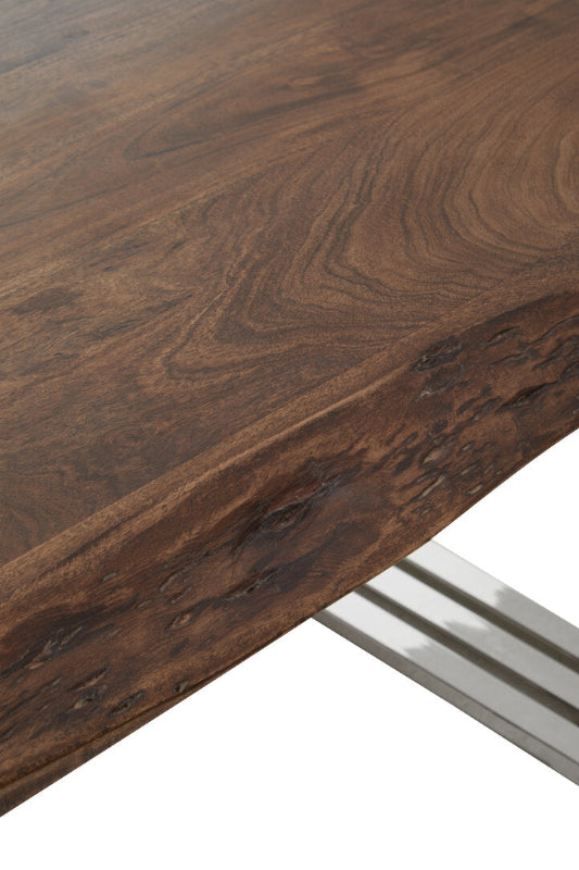 Close-up of a wooden table surface with a metal leg.