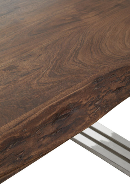 Close-up of a wooden table surface with a metal leg.