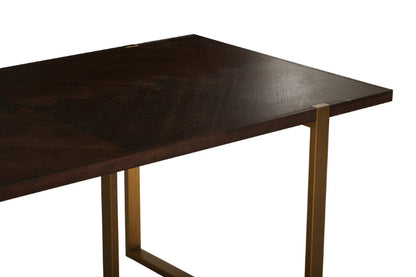 Dark wooden table with brass legs on a white background