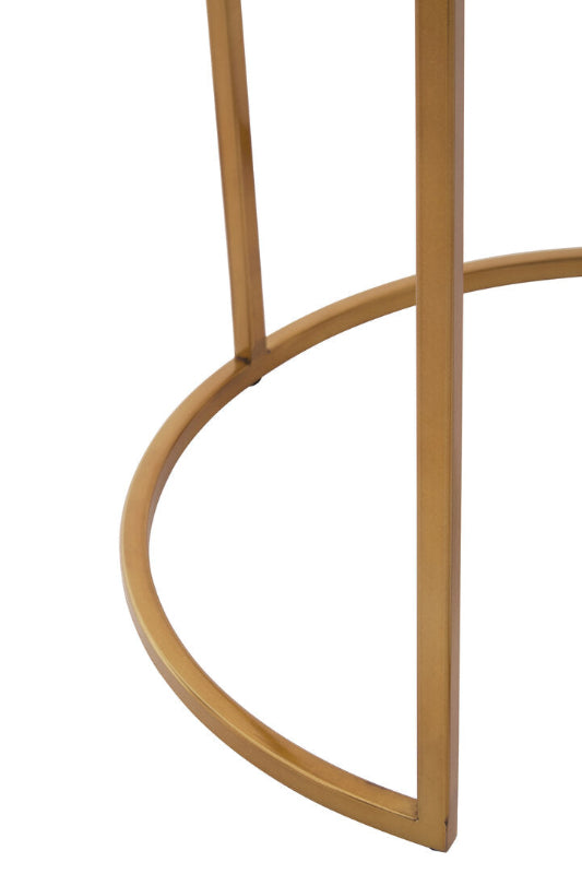 Close-up of a gold metal chair leg on a white background