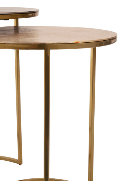 Nest of tables with gold metal legs on a white background