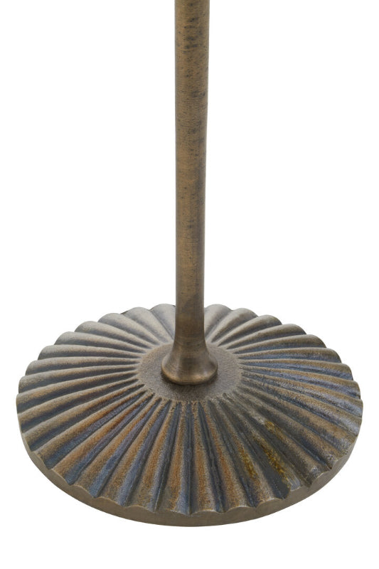 Decorative metal base with ribbed design on a white background