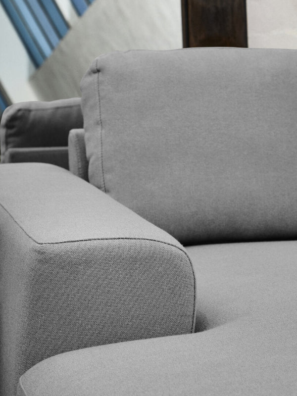 Close up of grey sofa armrest