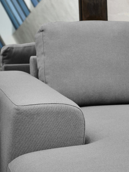 Close up of grey sofa armrest