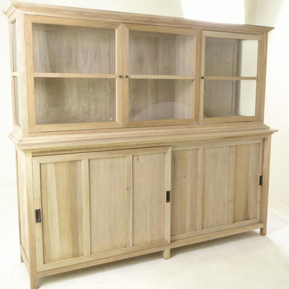 A light natural wood hutch cabinet with a three-door upper display section featuring glass panels and a lower cabinet section with paneled doors and dark metal handles, shown against a plain light background.