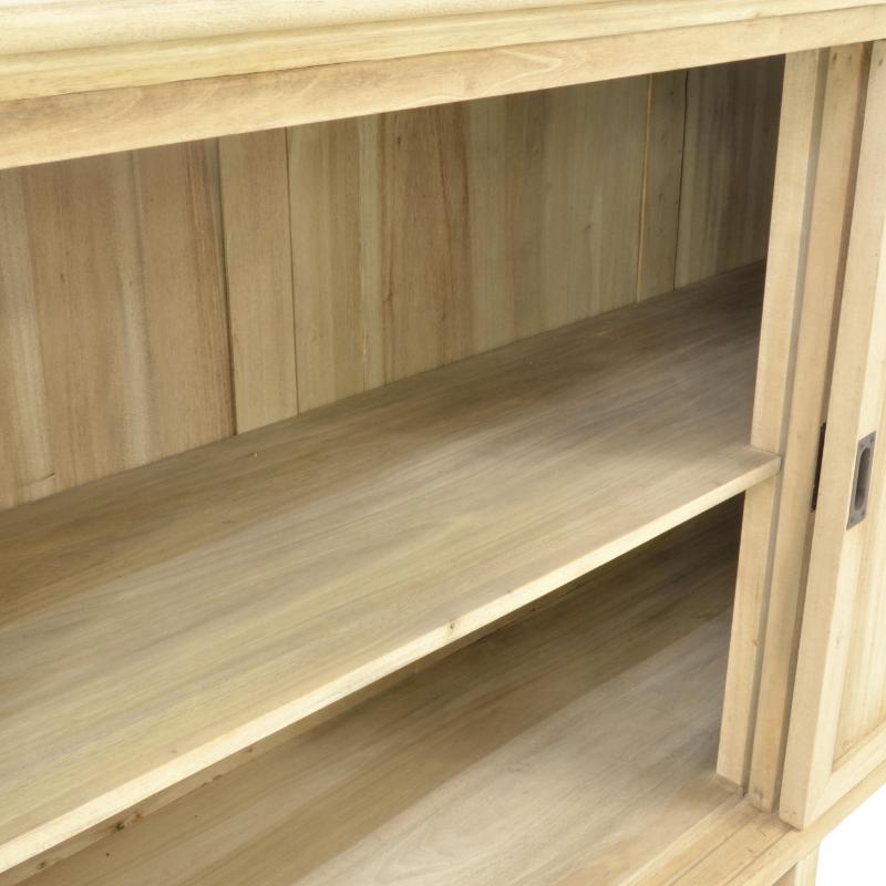 Close-up of a light natural wood cabinet or shelf unit with a single open shelf and a partially visible door with a small metal handle.