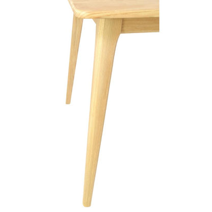 Close-up of a light natural wood table leg and part of the tabletop against a plain white background.