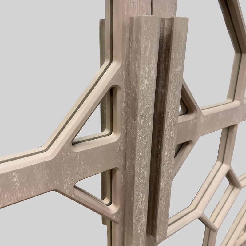 Close-up of a geometric wooden sculpture with a neutral background