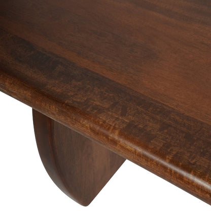 Close-up detail of a dark brown wooden table showing the rich wood grain on the tabletop and a matching curved wooden leg against a white background.
